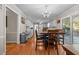 Eat-in kitchen with an adjacent dining area, all-white cabinets, and access to the outdoor deck at 347 Cook Rd, Elon, NC 27244