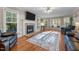 Cozy living room featuring a fireplace, hardwood floors, large windows, and comfortable seating at 347 Cook Rd, Elon, NC 27244