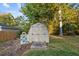 Outdoor shed with double doors and decorative accents, provides extra storage space at 347 Cook Rd, Elon, NC 27244