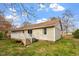 Exterior view showing a wood deck and beige siding of a house with a grassy lawn at 3490 Old Buies Creek Rd, Angier, NC 27501