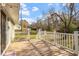 Exterior deck overlooking a well-maintained yard with a clear view of storage buildings under a clear sky at 3490 Old Buies Creek Rd, Angier, NC 27501
