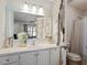 Bathroom with white vanity and mirror and a shower with a patterned curtain at 3490 Old Buies Creek Rd, Angier, NC 27501