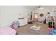 Spacious bedroom featuring a white dresser, a small trampoline, and lots of toys at 3490 Old Buies Creek Rd, Angier, NC 27501