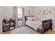 Comfortable bedroom with wooden floors and a large window at 3490 Old Buies Creek Rd, Angier, NC 27501
