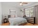 Comfortable bedroom with hardwood floors, a ceiling fan, and natural light at 3490 Old Buies Creek Rd, Angier, NC 27501