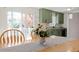 Dining room with a wooden table and chairs near a kitchen with green cabinetry at 3490 Old Buies Creek Rd, Angier, NC 27501