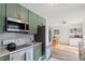 Well-equipped kitchen with stainless steel appliances and adjacent dining area at 3490 Old Buies Creek Rd, Angier, NC 27501
