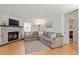 Open-concept living room with a brick fireplace and natural light at 3490 Old Buies Creek Rd, Angier, NC 27501