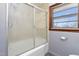 Bathroom with a tub/shower combination behind a sliding glass door at 369 Albany St, Burlington, NC 27215