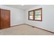 Bright bedroom features a window and neutral carpet at 369 Albany St, Burlington, NC 27215