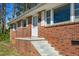Welcoming front entrance of a brick home featuring a small porch and steps at 369 Albany St, Burlington, NC 27215