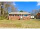 Charming one-story brick home with a well-maintained front yard and blue skies at 369 Albany St, Burlington, NC 27215