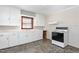 Well-lit kitchen features white cabinetry and vintage electric stove at 369 Albany St, Burlington, NC 27215