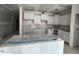 Unfinished kitchen featuring white cabinets and an island, still under construction at 381 Old Fashioned Way, Lillington, NC 27546