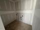Dedicated laundry room with utility hookups, providing a practical and organized space for laundry tasks and storage at 381 Old Fashioned Way, Lillington, NC 27546