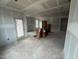 Spacious living room featuring unfinished drywall and a smooth ceiling, ready for customization at 381 Old Fashioned Way, Lillington, NC 27546