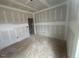 Spacious living room boasts high ceilings and an open doorway, offering flexibility and easy flow throughout the home at 381 Old Fashioned Way, Lillington, NC 27546