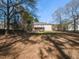 Spacious backyard featuring a deck, privacy fence, and mature trees, perfect for outdoor living at 382 Tomahawk Dr, Clayton, NC 27520
