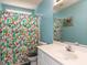Bright bathroom featuring colorful shower curtain and white vanity at 382 Tomahawk Dr, Clayton, NC 27520