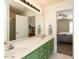 Bright bathroom featuring a double sink vanity and a view into the primary bedroom at 382 Tomahawk Dr, Clayton, NC 27520