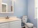 Well-lit bathroom with vanity, toilet, and a calming blue color scheme at 382 Tomahawk Dr, Clayton, NC 27520