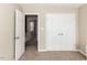 Bedroom with neutral carpet flooring, closet, and view to hallway at 382 Tomahawk Dr, Clayton, NC 27520