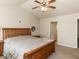 A tranquil bedroom with a wooden bed frame, ceiling fan, and soft lighting at 382 Tomahawk Dr, Clayton, NC 27520