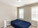 Cozy bedroom features two windows and neutral paint at 382 Tomahawk Dr, Clayton, NC 27520