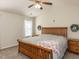 Cozy bedroom with a ceiling fan, comfortable bed, and natural light at 382 Tomahawk Dr, Clayton, NC 27520