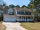 Charming two-story home with a large front porch, attached garage, and well-maintained lawn at 382 Tomahawk Dr, Clayton, NC 27520