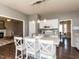 Bright kitchen featuring an island with bar seating, white cabinets, and hardwood floors at 382 Tomahawk Dr, Clayton, NC 27520