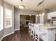Bright kitchen featuring an island with bar seating, white cabinets, and hardwood floors at 382 Tomahawk Dr, Clayton, NC 27520