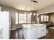 Bright kitchen featuring an island with bar seating, white cabinets, and hardwood floors at 382 Tomahawk Dr, Clayton, NC 27520