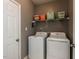 Functional laundry room complete with washer, dryer, and storage shelves at 382 Tomahawk Dr, Clayton, NC 27520
