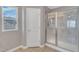 Bathroom with a glass-enclosed shower and a window that brings in natural light at 3925 Massey Pointe Ct, Raleigh, NC 27616