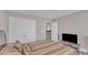Neutral bedroom with a plush bed, television and an easily accessible closet at 3925 Massey Pointe Ct, Raleigh, NC 27616
