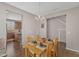 Bright dining room with hardwood floors, stylish chandelier, and access to the kitchen at 3925 Massey Pointe Ct, Raleigh, NC 27616