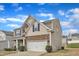 Stunning two-story home featuring a stone and siding exterior, a neatly landscaped yard, and an attached two-car garage at 3925 Massey Pointe Ct, Raleigh, NC 27616