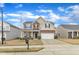 Inviting two-story home featuring a stone facade, attached garage, and well-manicured lawn at 3925 Massey Pointe Ct, Raleigh, NC 27616