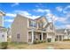 Charming two-story home with a stone-accented exterior, a well-maintained lawn, and an attached two-car garage under a blue sky at 3925 Massey Pointe Ct, Raleigh, NC 27616