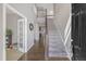 Grand foyer with hardwood floors and staircase leading to the upper level, showcasing an open design at 3925 Massey Pointe Ct, Raleigh, NC 27616