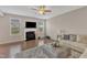 Inviting living room with a cozy fireplace, hardwood floors, and natural light from the large windows at 3925 Massey Pointe Ct, Raleigh, NC 27616