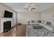 Bright living room featuring a cozy fireplace, ceiling fan, and hardwood flooring with stylish decor at 3925 Massey Pointe Ct, Raleigh, NC 27616