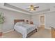 Relaxing bedroom featuring tray ceilings, ceiling fan, and neutral carpet flooring at 3925 Massey Pointe Ct, Raleigh, NC 27616