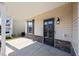 View of back porch area with stone detail, a window, door, and light fixture at 4044 Dunkirk Dr, Burlington, NC 27215