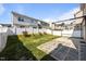 Spacious backyard featuring stone patio, pergola, green grass, and white fence at 4044 Dunkirk Dr, Burlington, NC 27215