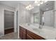 Bathroom featuring a double sink vanity with wood cabinets and a large mirror at 4044 Dunkirk Dr, Burlington, NC 27215