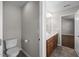Neutral bathroom with a toilet and a double sink vanity with a view to the room beyond at 4044 Dunkirk Dr, Burlington, NC 27215