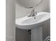 Close up of the white sink and faucet in the bathroom with a pedestal sink at 4044 Dunkirk Dr, Burlington, NC 27215