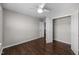 Spacious bedroom with hardwood floors, a ceiling fan, and a closet for ample storage at 4044 Dunkirk Dr, Burlington, NC 27215